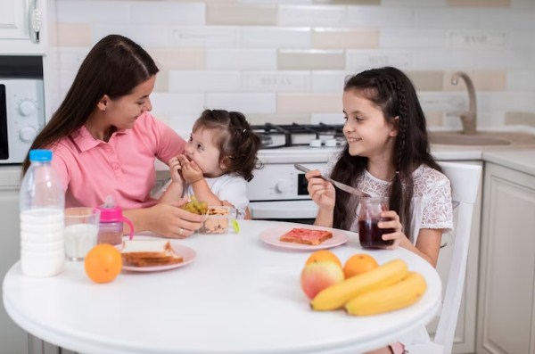 Anak-Anak dan Ibu Makan Bersama di Meja Makan