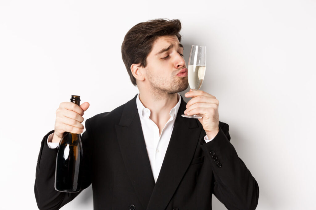 Handsom Man Suit Kissing Glass with Champagne Getting Drunk