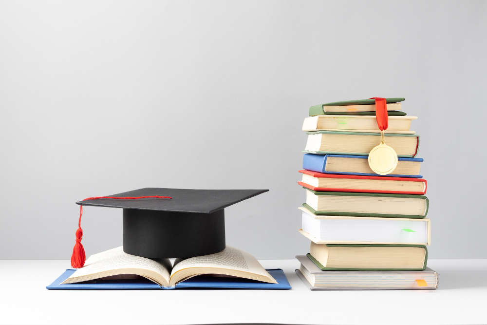 front view stacked books graduation cap open book education day