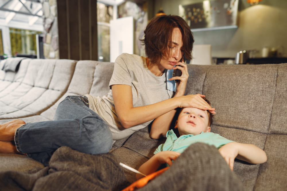 mother with littler son sitting home quarantine 1