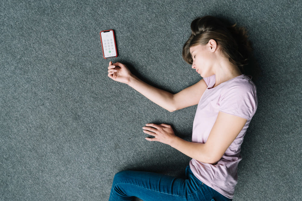 overhead view unconscious woman lying near cell phone carpet 1